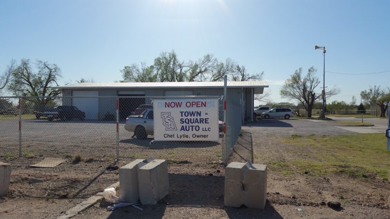 Town Square Auto building with the owner banner out front